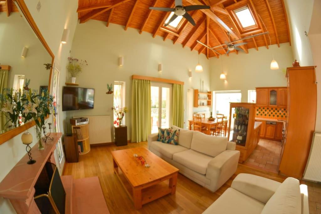 a living room with a couch and a table at Artemis House in Agios Georgios Pagon