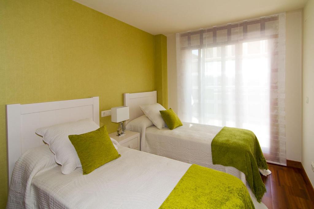 Postel nebo postele na pokoji v ubytování CANELAS SUITES ÁTICO Amplias Terrazas