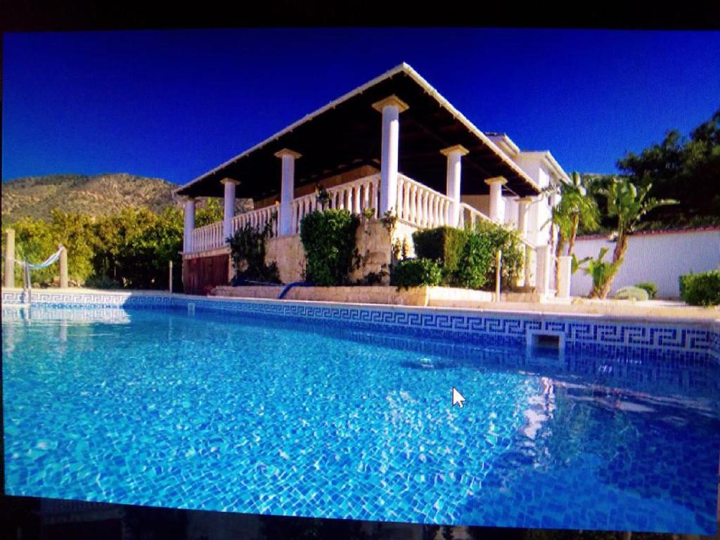 a large swimming pool in front of a house at Pomos Harbourbiew Villa in Pomos