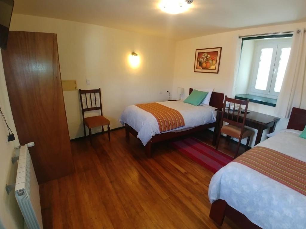 Postel nebo postele na pokoji v ubytování Hostal Corihuasi