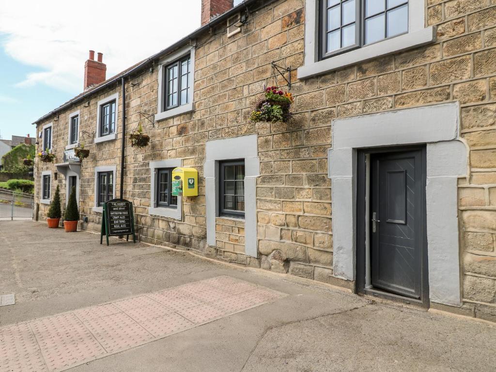 a brick building with a door on the side of it at The Loft at The George in Chesterfield