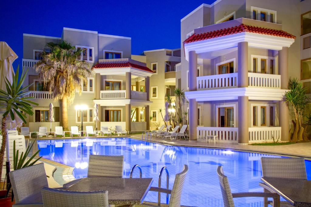 a hotel with a swimming pool at night at Stavroula Hotel Palace in Kissamos