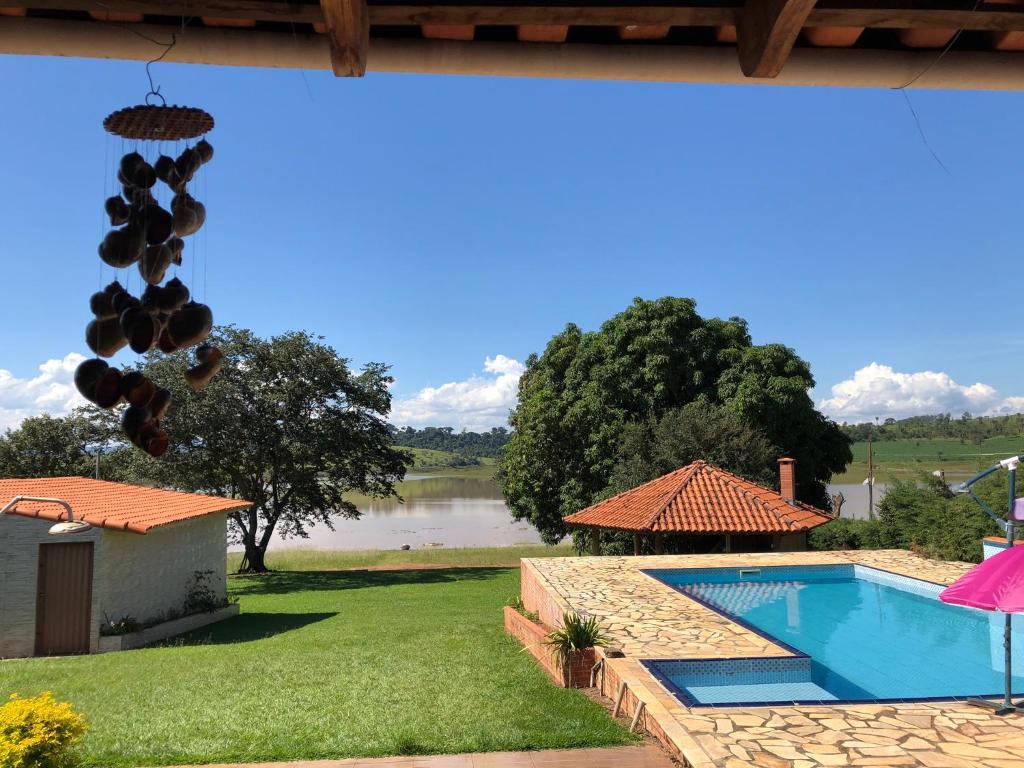 a swimming pool with a view of a lake at Pedacinho do Paraiso in CÃ¡ssia