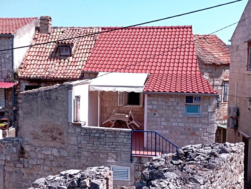 a house with a red roof in a city at Ana Apartments in Vis