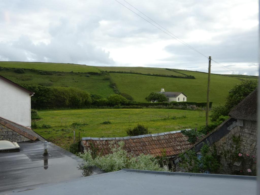 a view of a field with a house in the distance at The Sloop Inn in Kingsbridge