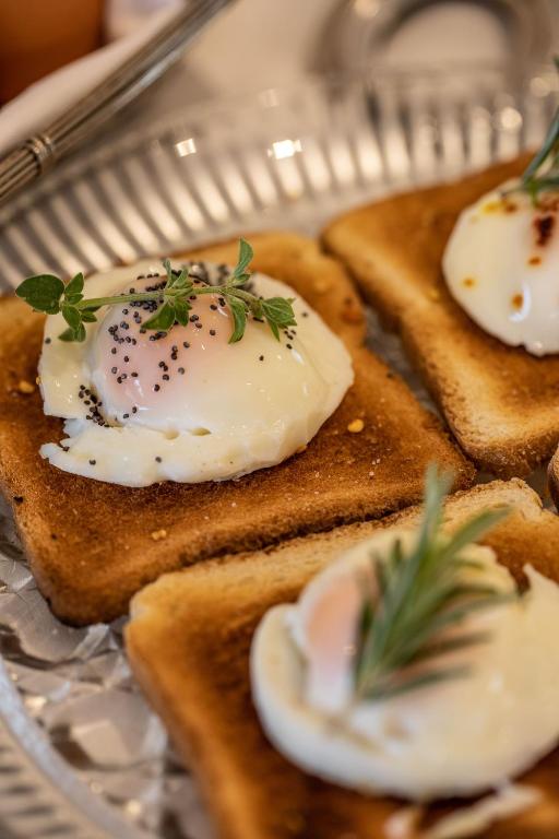a plate of food with eggs on toast at Hotel Albatros Varigotti in Varigotti