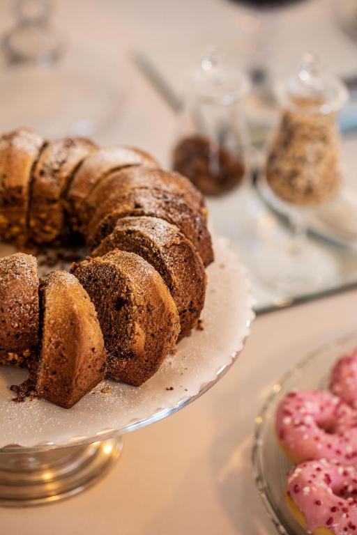 a bundt cake on a plate on a table with other desserts at Hotel Albatros Varigotti in Varigotti