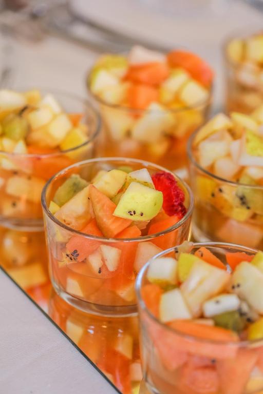 a group of glass cups filled with fruit and vegetables at Hotel Albatros Varigotti in Varigotti