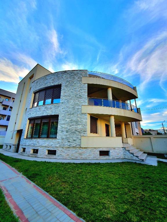 a large building with a round building at Casa Maria Mamaia Nord in Mamaia Sat/Năvodari