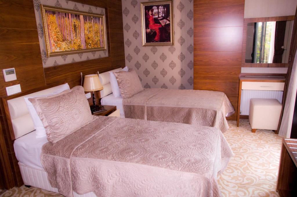 Postel nebo postele na pokoji v ubytování Kerimbey Hotel