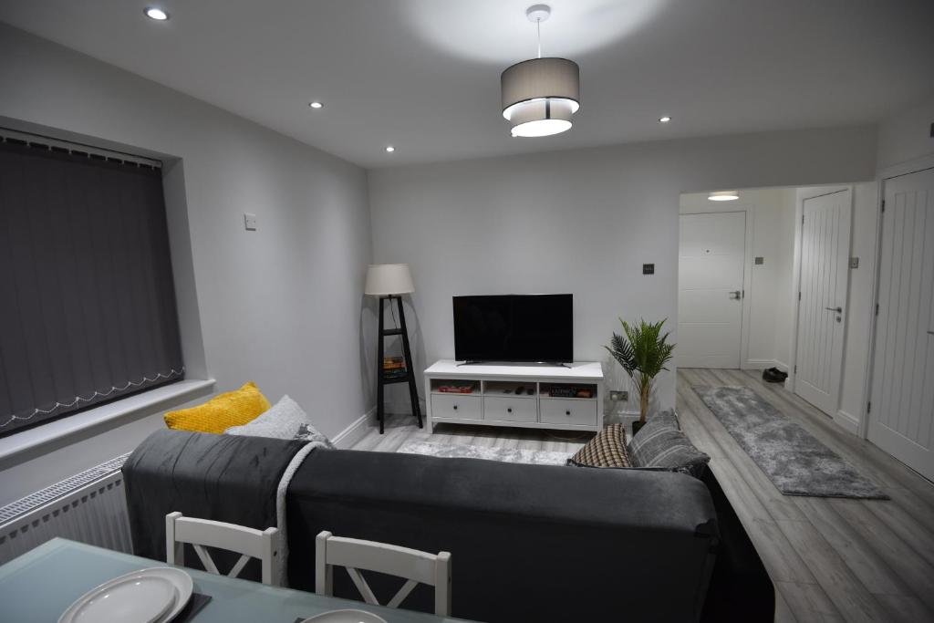 Cozy! 2-bedroom Exclusive Apartment near Bristol City Centre Easton Speedwell sleeps upto 6 في بريستول: غرفة معيشة مع أريكة وتلفزيون بشاشة مسطحة