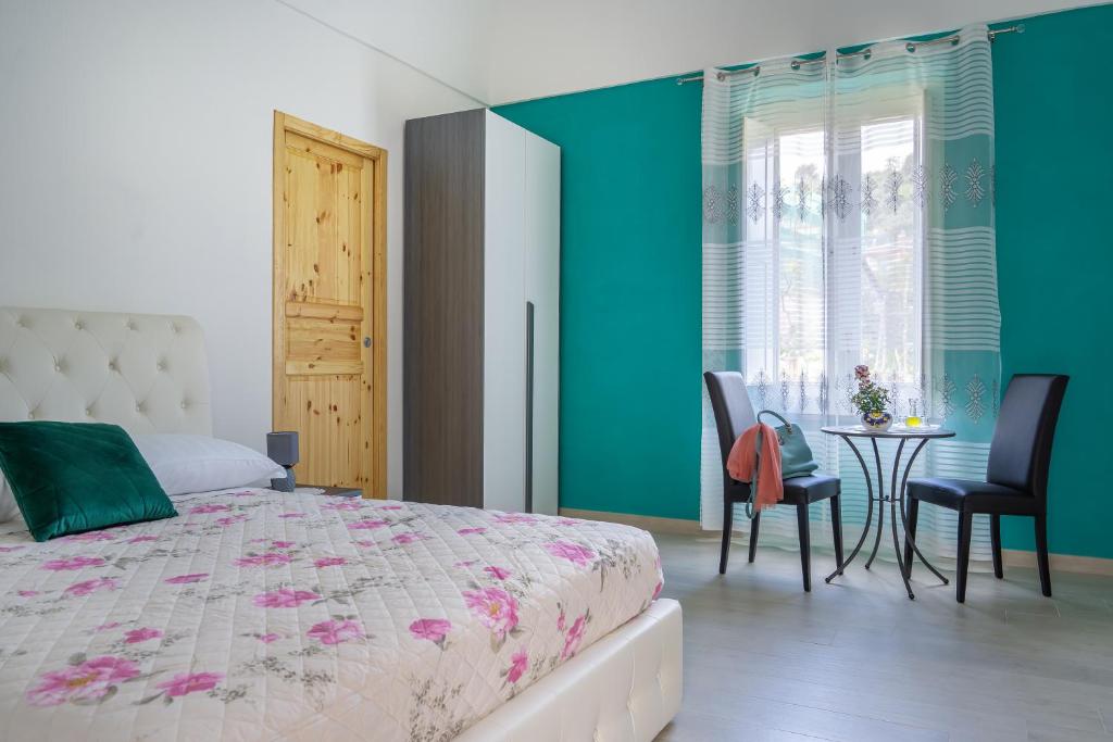 a bedroom with a bed and a table and chairs at Il Casale di Don Matteo in Vico Equense