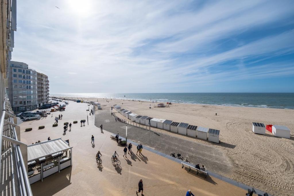 a view of a beach with people and the ocean at Ostend Luxury Seasight Apartment in Ostend