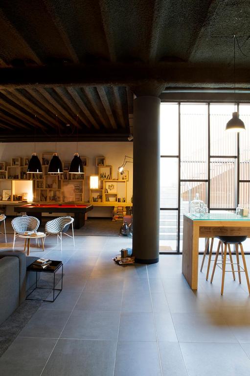 a living room with a table and chairs in a room at TOC Hostel Barcelona in Barcelona