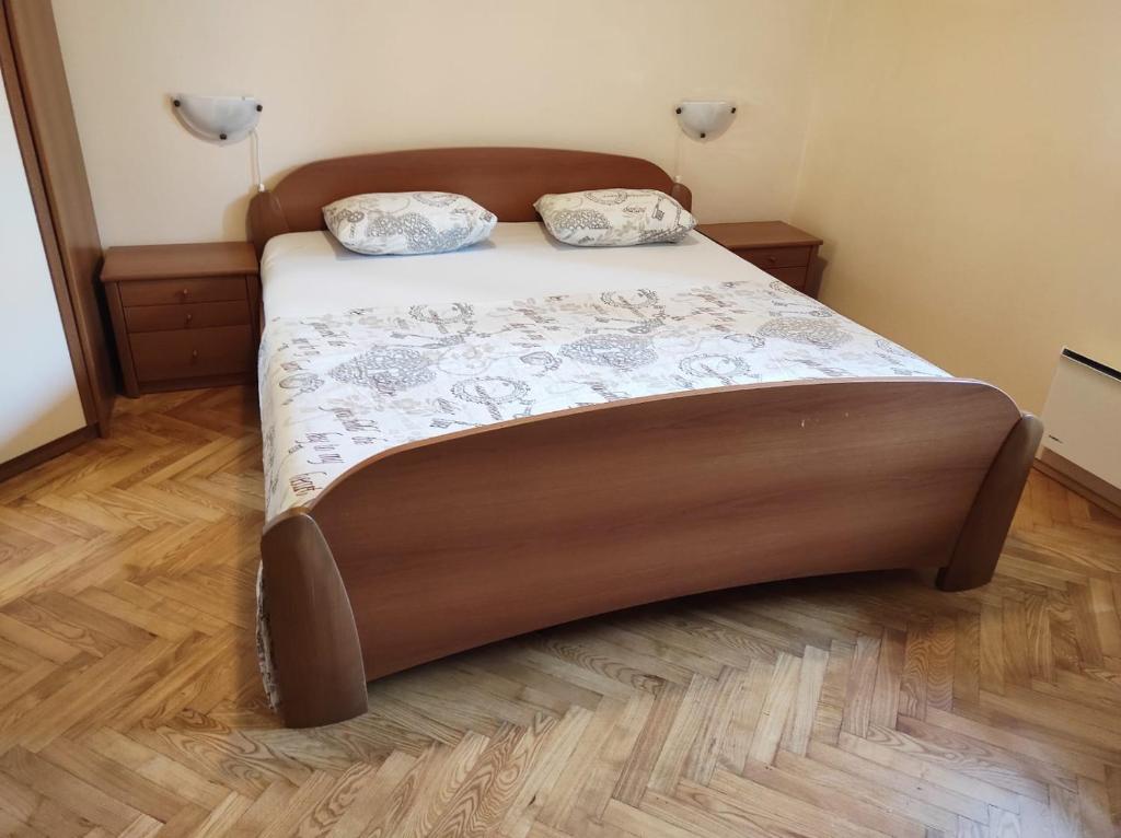 a bed with two pillows on it in a bedroom at Apartment MM Split in Split