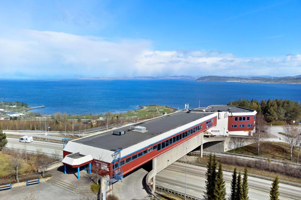 a train station with a train on a bridge at Stav Hotel in Malvik