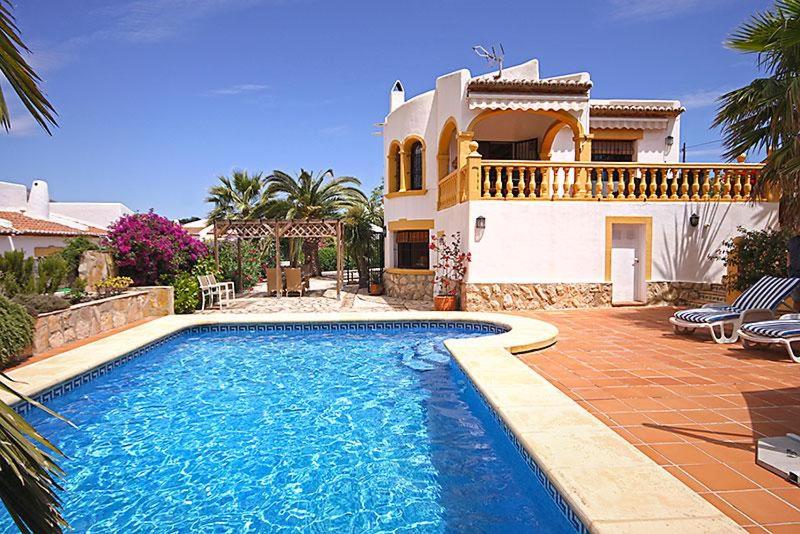 a house with a swimming pool in front of a house at Sol in Jávea