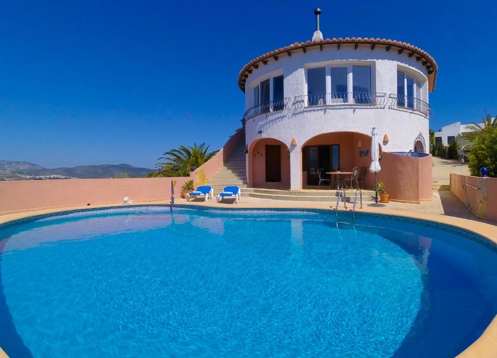 a house with a large swimming pool in front of it at Villa Linda Vista - stunning views - by Holiday Rentals Villamar in Benitachell