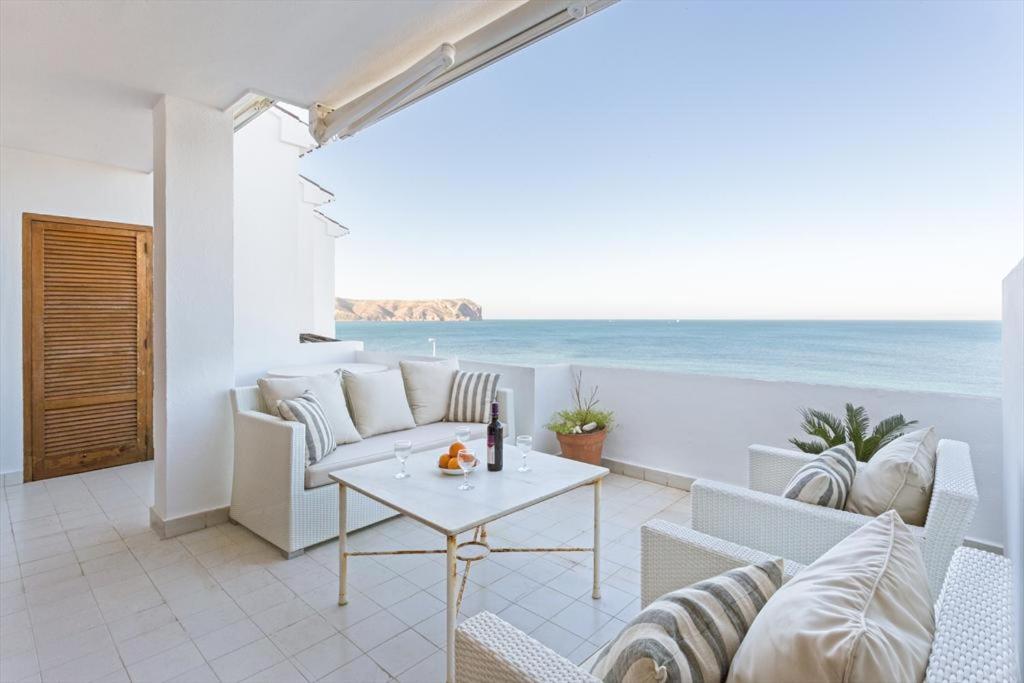 a living room with a view of the ocean at Jardines de Karine in Jávea