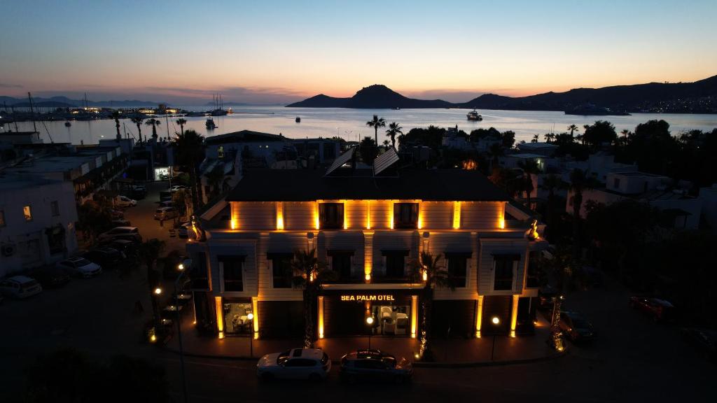 an aerial view of a building with lights at night at Sea Palm Otel Yalıkavak in Yalıkavak