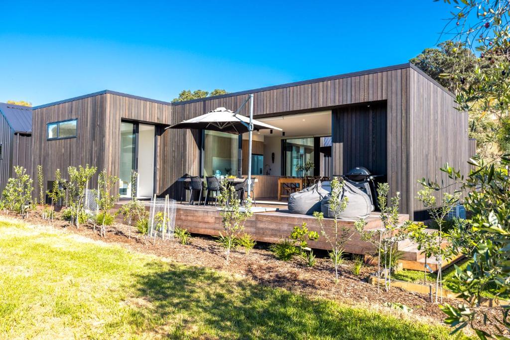 a house with a garden in front of it at Wavesong Mahe in Onetangi