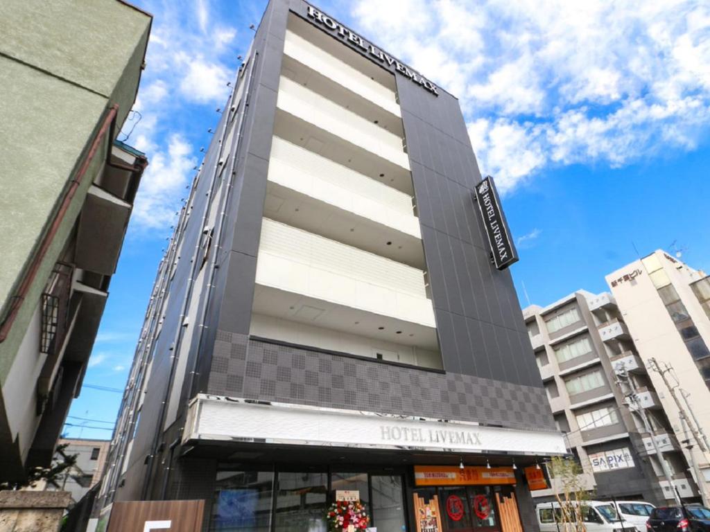 a building in the middle of a city at HOTEL LiVEMAX Chiba-Ekimae in Chiba
