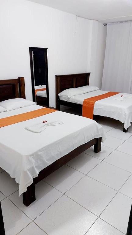 Postel nebo postele na pokoji v ubytování Aparta Hotel El Cacique Upar