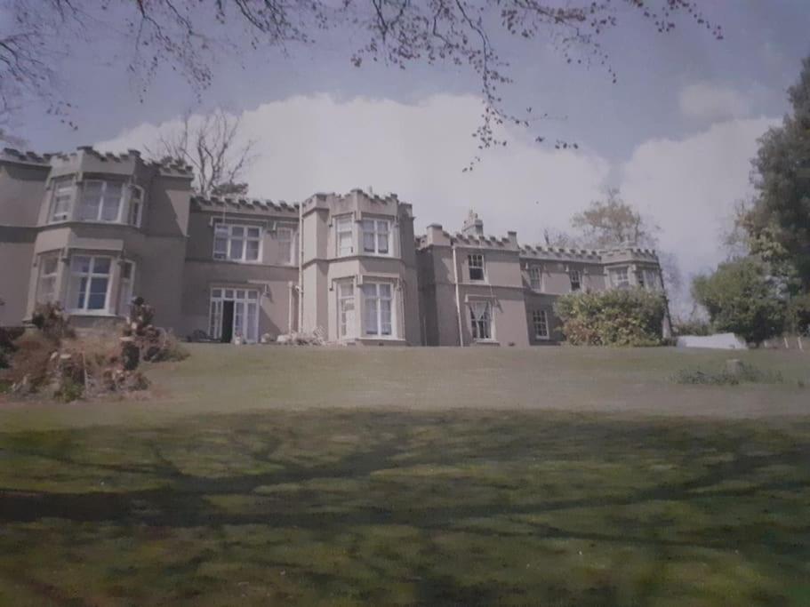 a large house with a large lawn in front of it at Home of author of the famous Jungle Book in Torquay