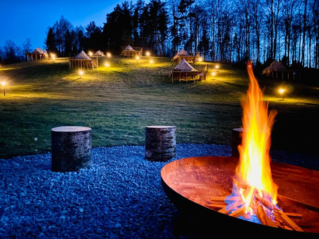 a fire pit in a field at night at Melody in Milwino