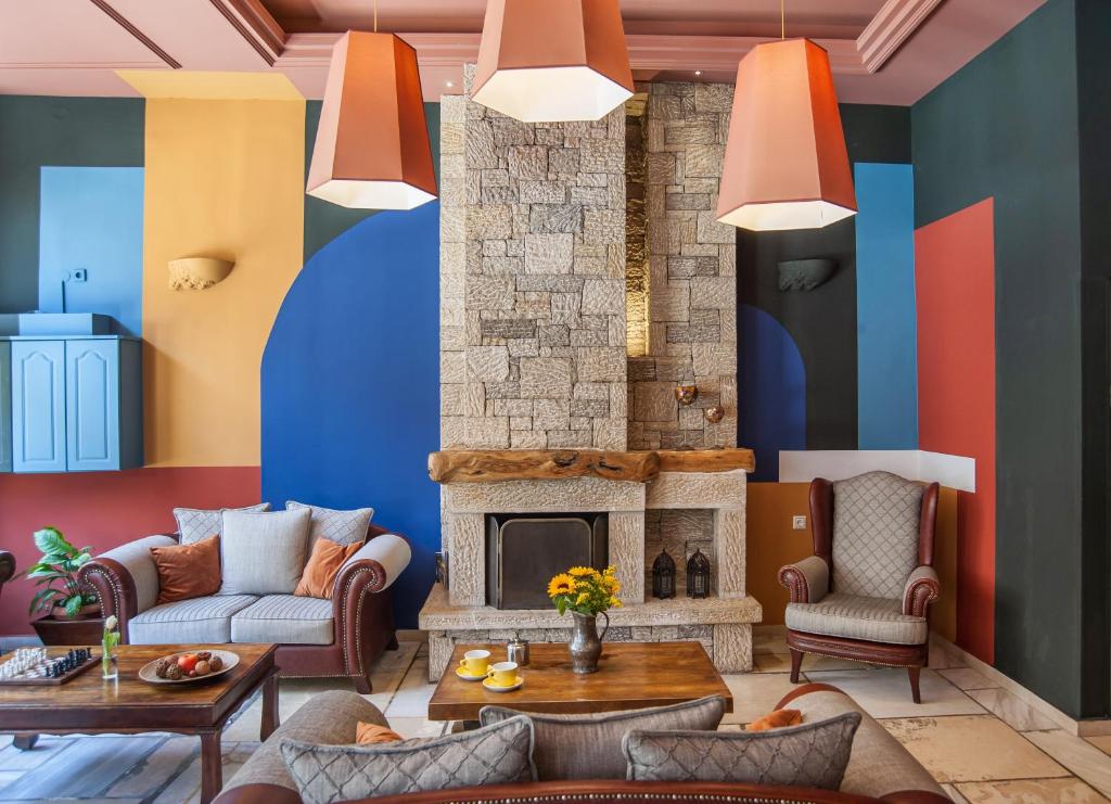 a living room with colorful walls and a fireplace at Parnassos Delphi Hotel in Delfoi