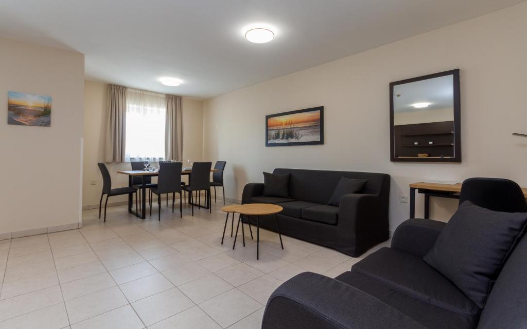 a living room with a couch and chairs and a table at Ponent 612 in Marina Portoroz by Locap Group in Portorož
