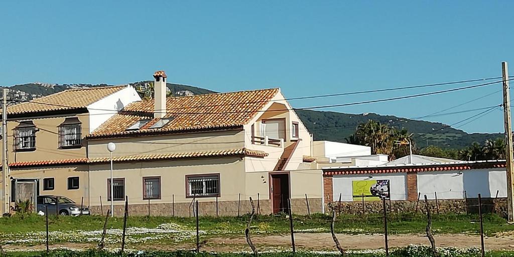 a white house with a fence in front of it at SON DE MAR in Bolonia