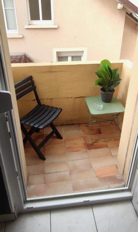 a chair and a table on a patio at Résidence Sainte-Cécile in Thionville