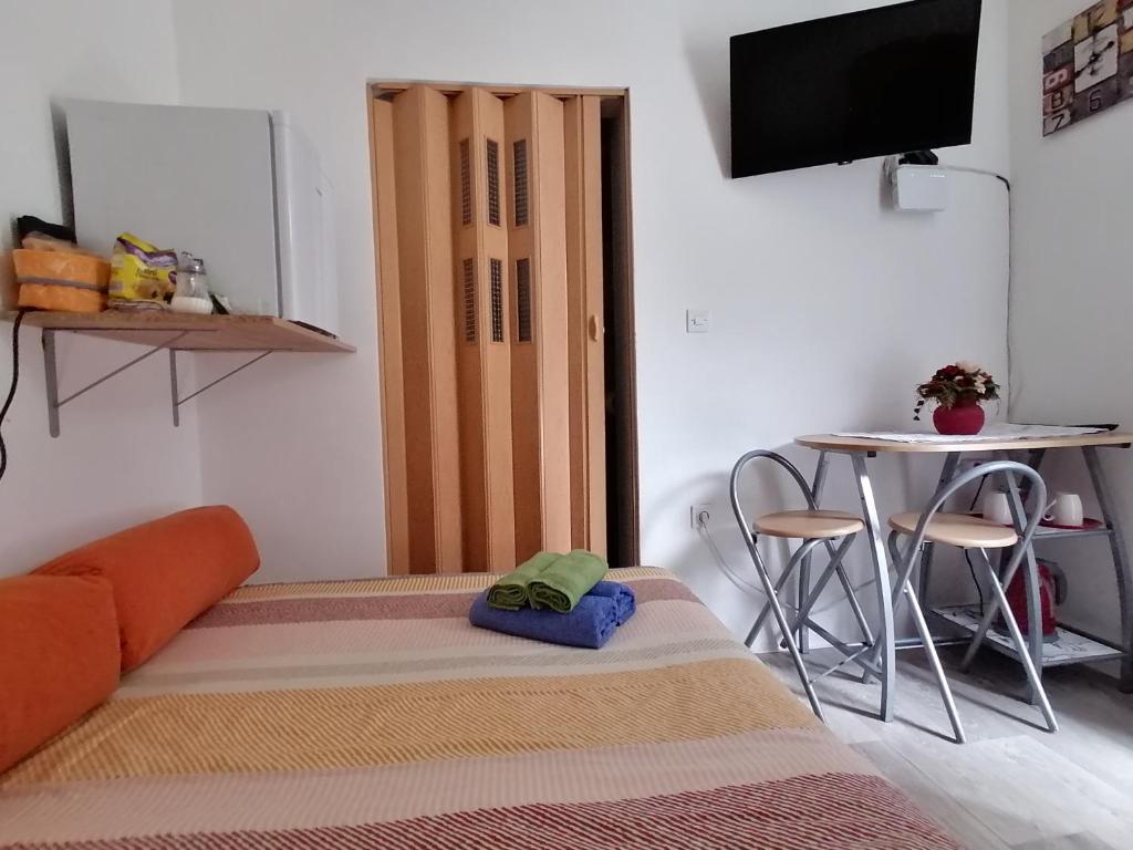 a room with a bed and a table and a television at "iDea" Private entrance near Bačvice Beach, Center City in Split