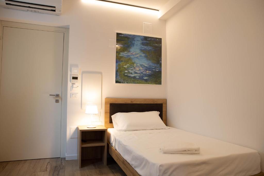 Łóżko lub łóżka w pokoju w obiekcie Vespasiani Suites