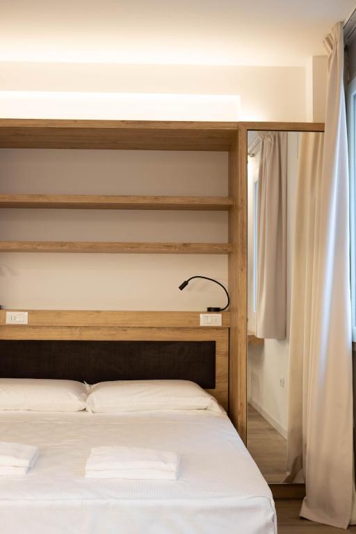 Łóżko lub łóżka w pokoju w obiekcie Vespasiani Suites