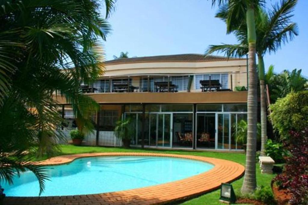 a house with a swimming pool in front of it at The Sandringham Bed and Breakfast in Durban