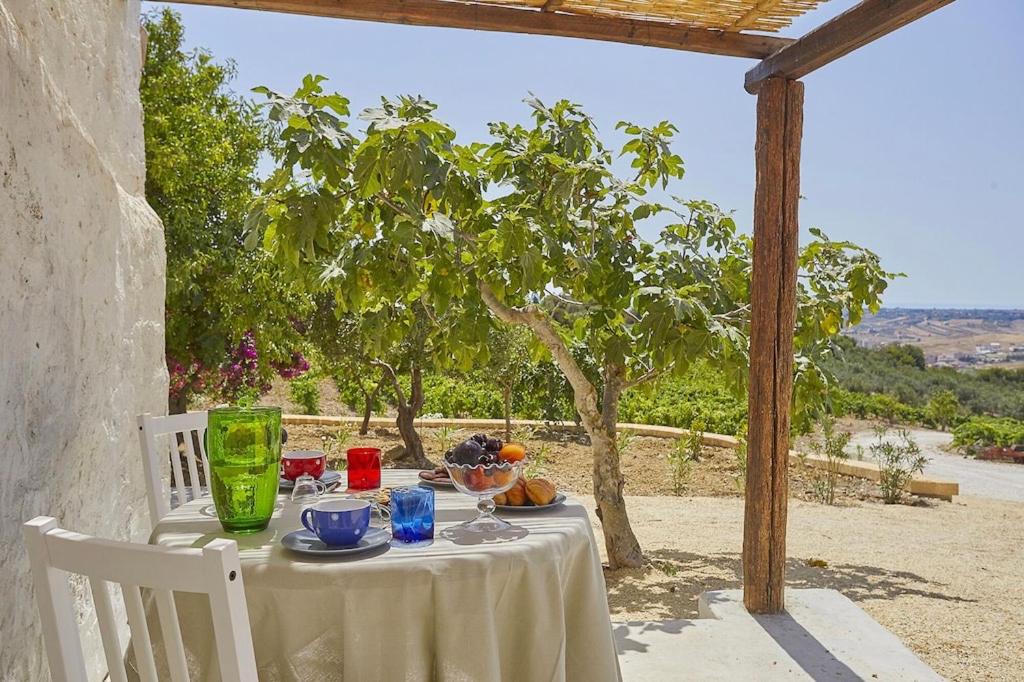 a table with a bowl of fruit on it at Casale Monte Kronio by Wonderful Italy in Sciacca