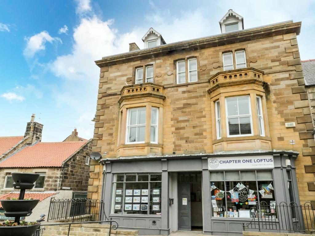 a large brick building with a store front at Flat 3 in Saltburn-by-the-Sea