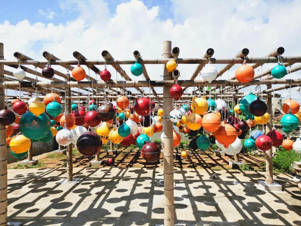 a bunch of colorful glass ornaments on a pole at Early Summer in Huxi