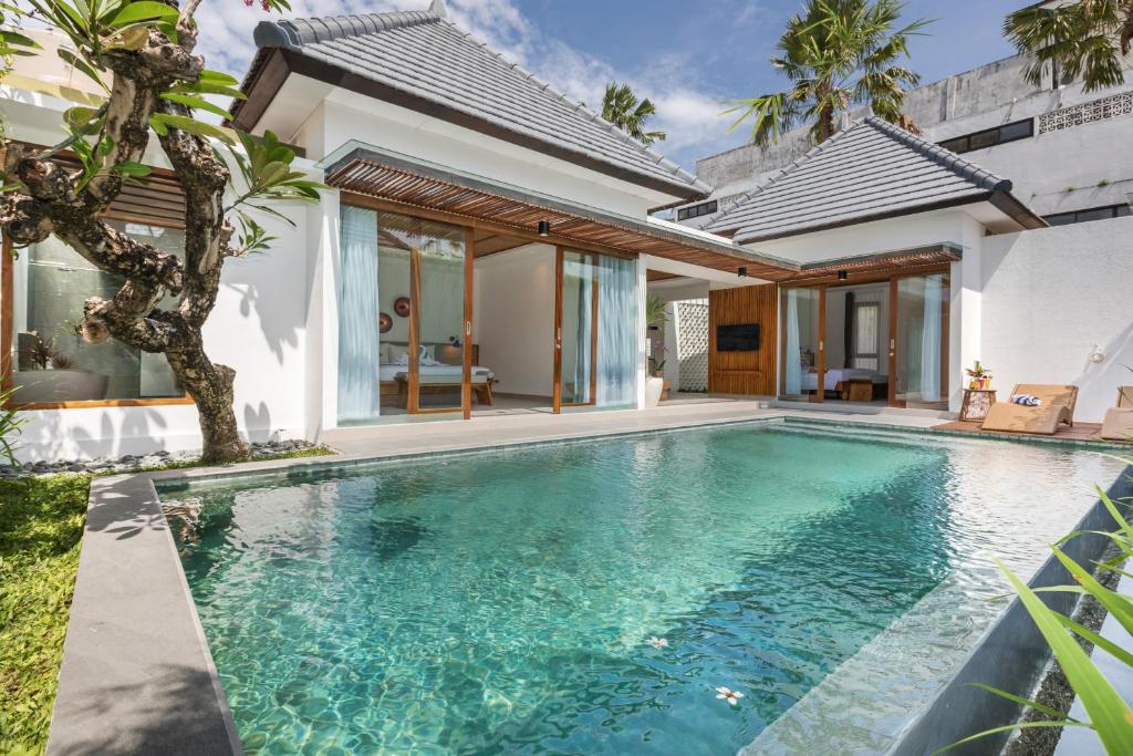 a swimming pool in the backyard of a villa at Fenosa Seminyak Villas by Nagisa Bali in Seminyak