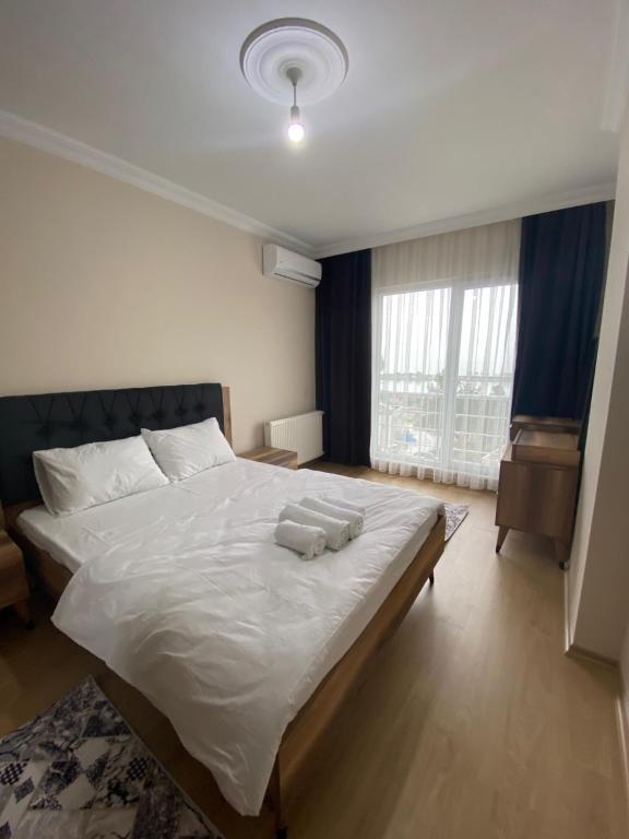 Säng eller sängar i ett rum på Kıvanç Residence