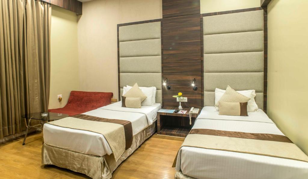 Postel nebo postele na pokoji v ubytování The Citi Residenci Hotel - Durgapur