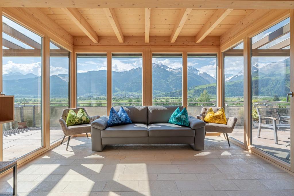 a living room with a couch and some mountains at Chalet Oxygen in Fürth