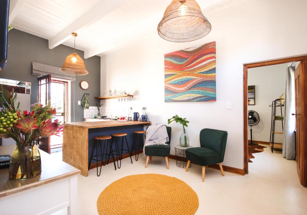 a kitchen and living room with a table and chairs at Videira-on-Mitchell in Riversdale