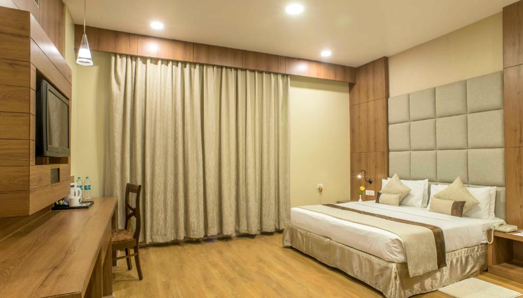 Postel nebo postele na pokoji v ubytování The Citi Residenci Hotel - Durgapur