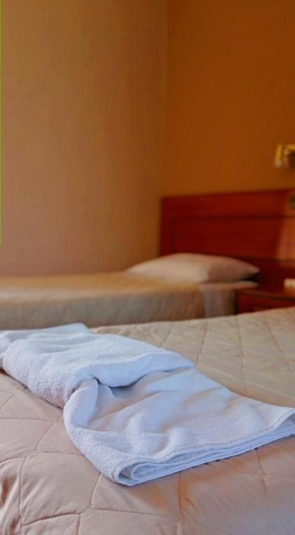 A bed or beds in a room at Maria's Beach Apartments