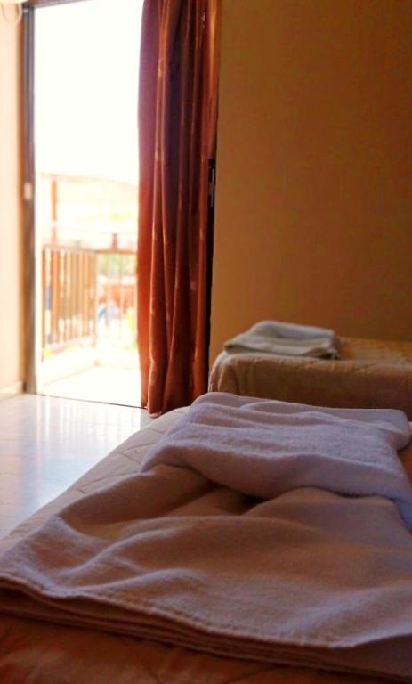 A bed or beds in a room at Maria's Beach Apartments