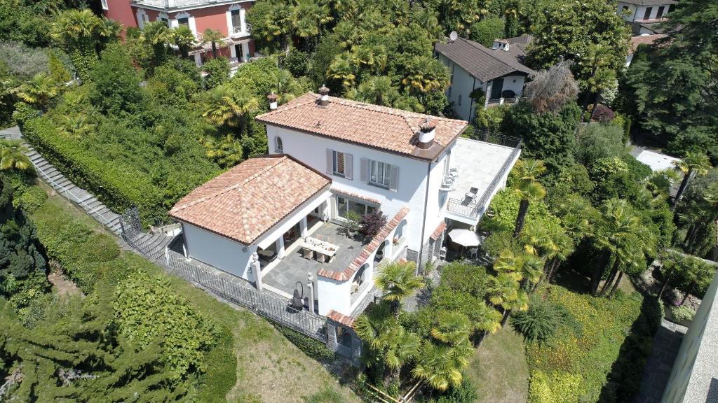 an aerial view of a white house with a fence at Villa Incanto in Ascona