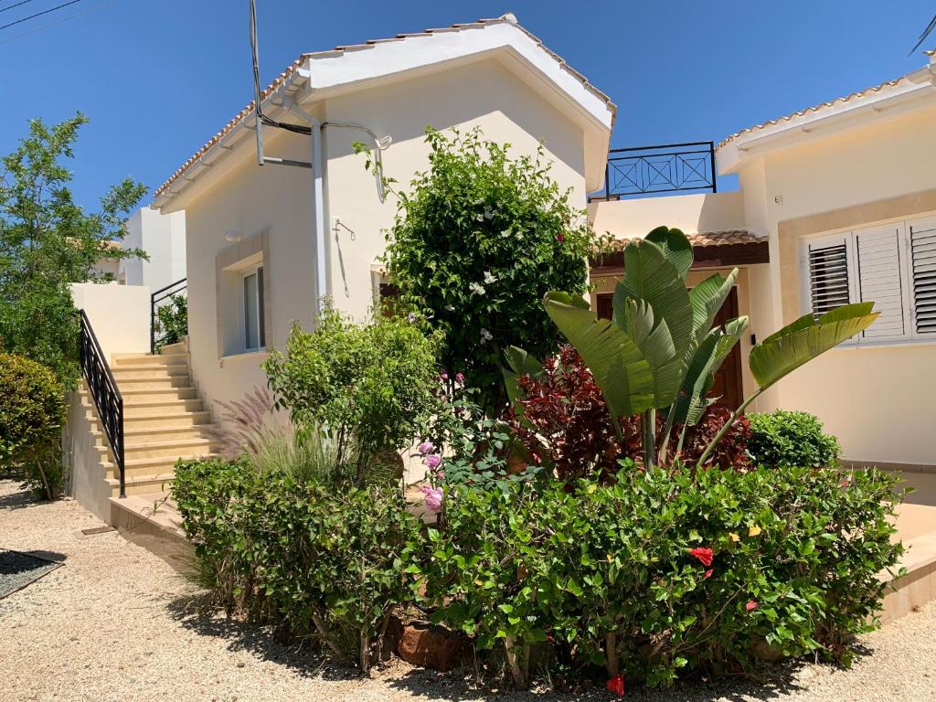 a house with some plants in front of it at Beach Villa Sofia in Neo Chorio